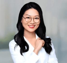 A woman with long black hair wearing glasses.